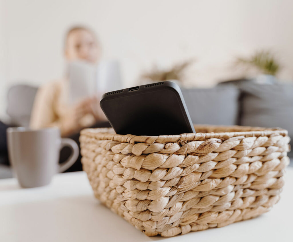 woman taking a break from her cellphone and putting it in basket